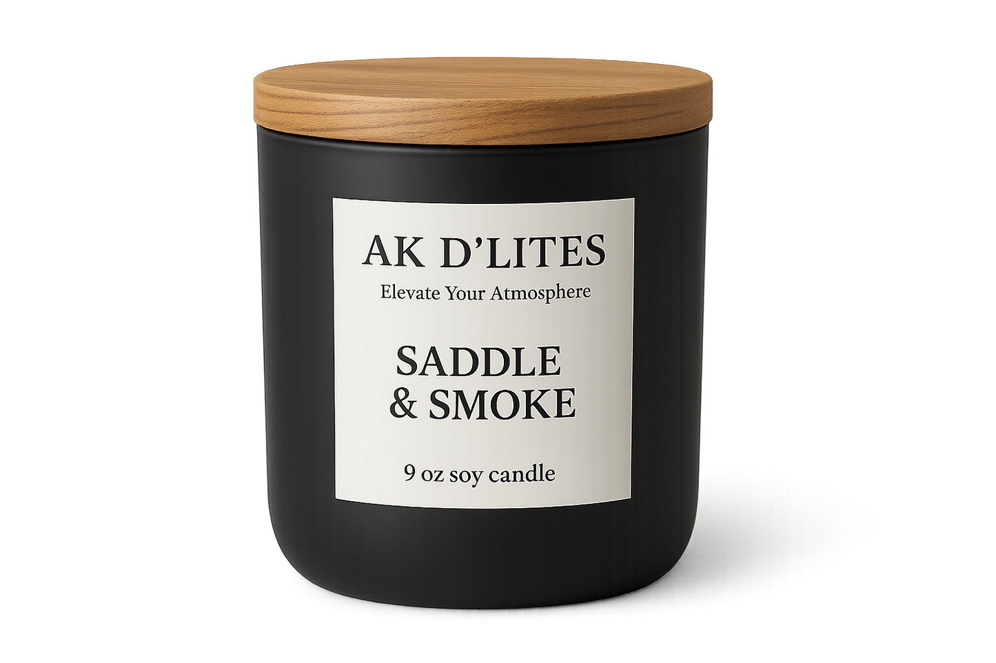 black matte candle jar with a white label and light brown wooden lid with AK D'LITES logo below the logo in a smaller font Elevate Your Atmosphere with the scent SADDLE & SMOKE and at the bottom in a smaller font 9 oz soy candle Transparent background