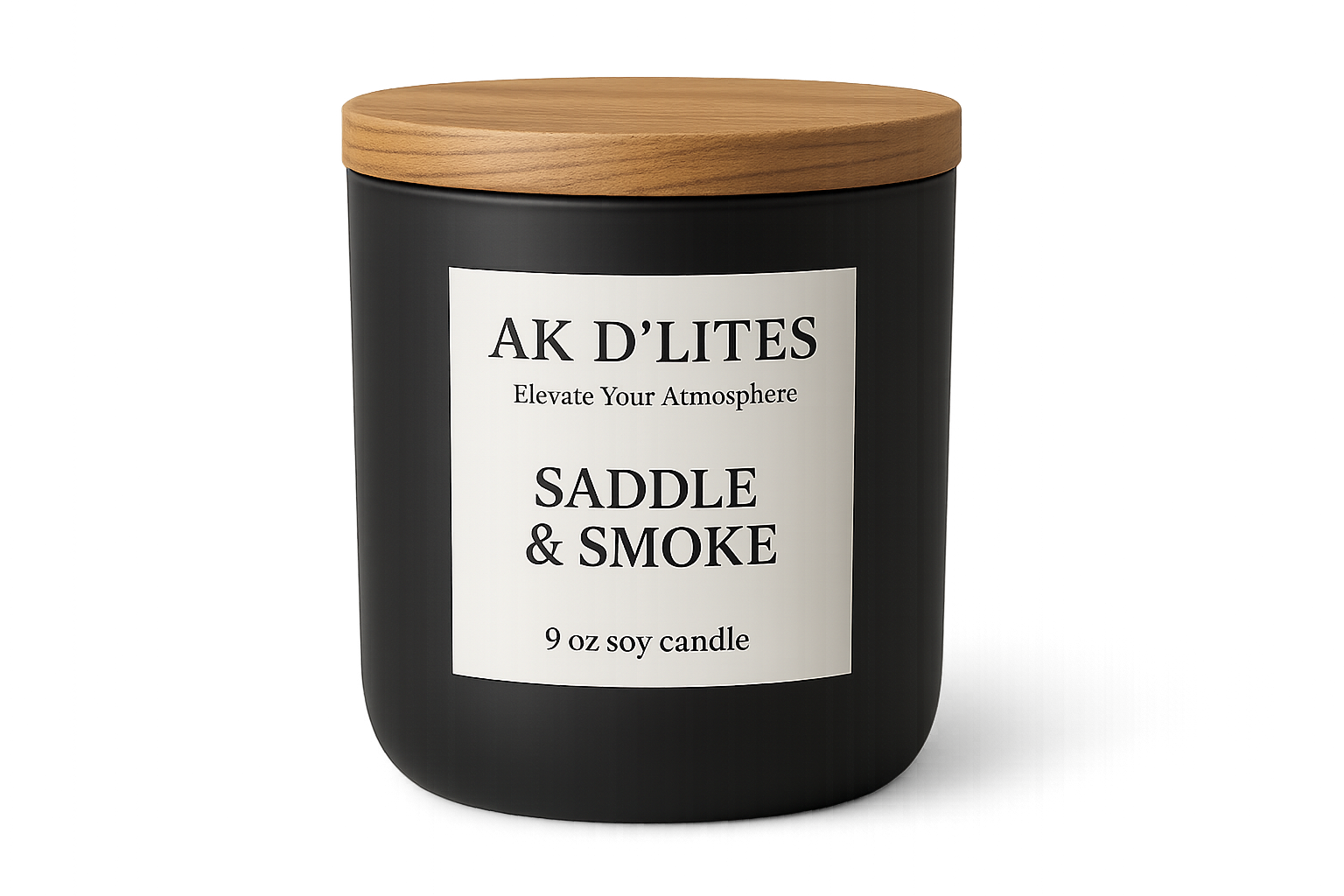 black matte candle jar with a white label and light brown wooden lid with AK D'LITES logo below the logo in a smaller font Elevate Your Atmosphere with the scent SADDLE & SMOKE and at the bottom in a smaller font 9 oz soy candle Transparent background
